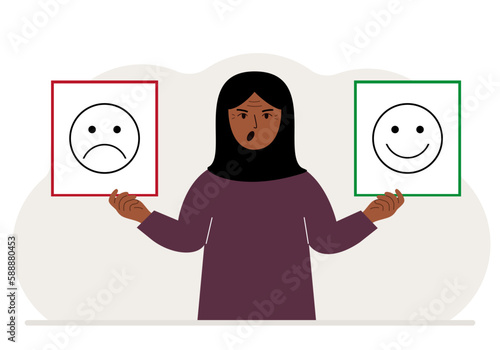 Screaming woman holds a card with a sad emoji in one hand and a smiling emoji in the other hand. The concept of emotions, masks or psychological help.