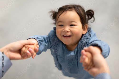 Asian Little Baby Girl Holding Hands With Mommy Spinning Indoor