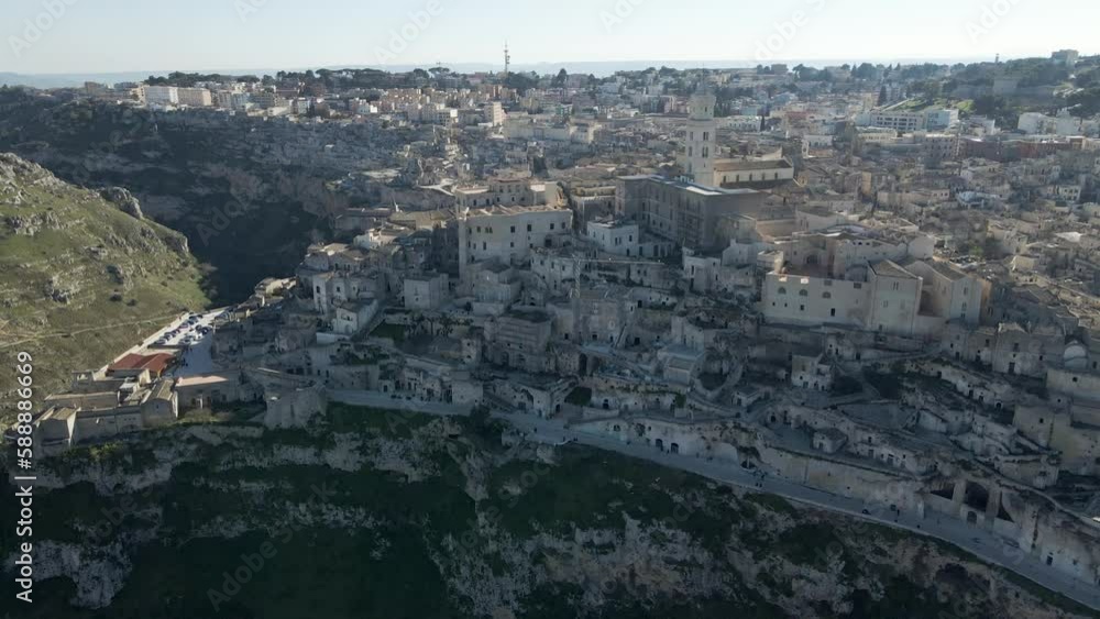 Aerial view of Sassi di Matera at sunlight, an ancient old town along the mountain crest, Matera, Basilicata, Italy. Aerial view of Sassi di Matera at sunlight, an ancient old town along the mountain crest, Matera, Basilicata, Italy.