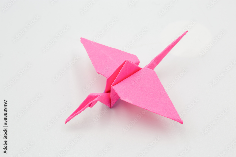 Hand picked pink paper crane origami closeup Hand picked pink paper crane origami closeup
