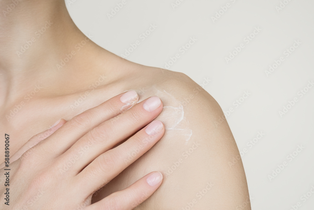 Fototapeta premium a woman applies moisturizing lotion to the body. skin care concept