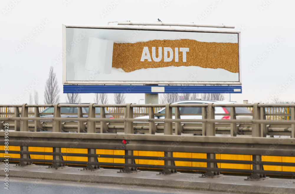 On the highway there is an advertising billboard with the image and the inscription - AUDIT On the highway there is an advertising billboard with the image and the inscription - AUDIT