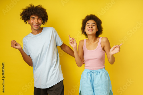 Happy and carefree boyfriend and girlfriend dance together