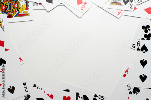 Scattered Playing Cards Bordering the Edges of a White Background