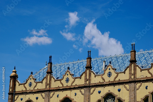 Art Nouveau, Secessionist style facade detail in Budapest, Hungary. artistic colorful enamel clay tile roof. landmark building. rich enamel finished ceramic decoration. architecture concept. blue sky photo