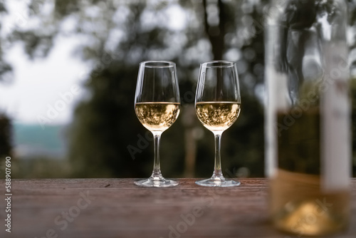 Two glasses of wine on table outdoors 