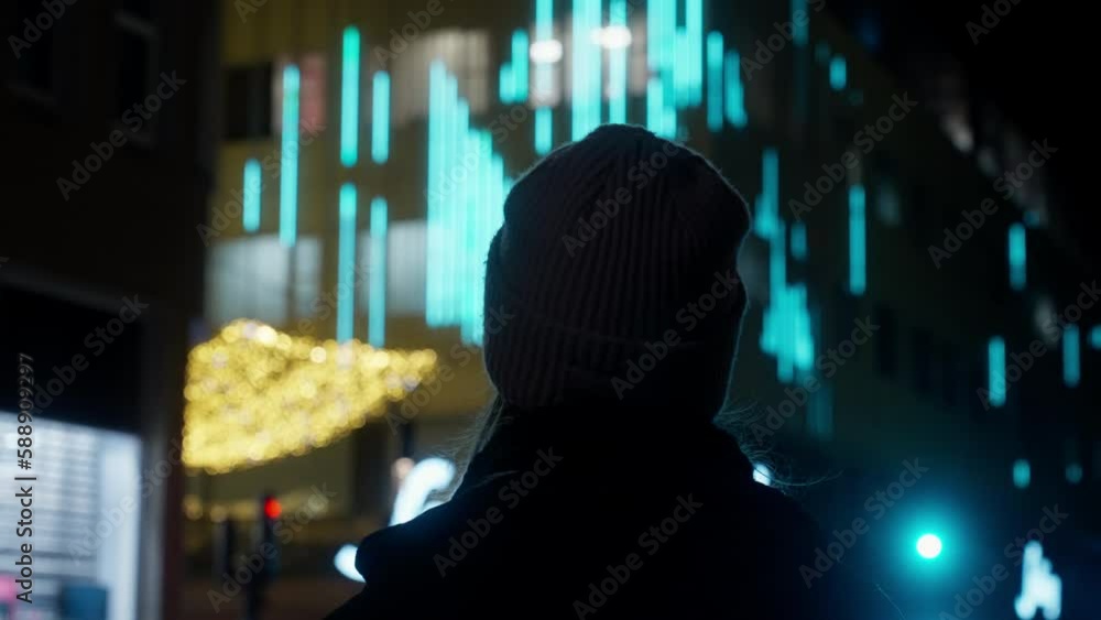 Back View Of A Girl Looking At A Building With Blue Lights Back View Of A Girl Looking At A Building With Blue Lights
