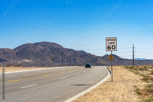 A 60 Speed Limit street sign on a on rural road in the Mojave Desert in California