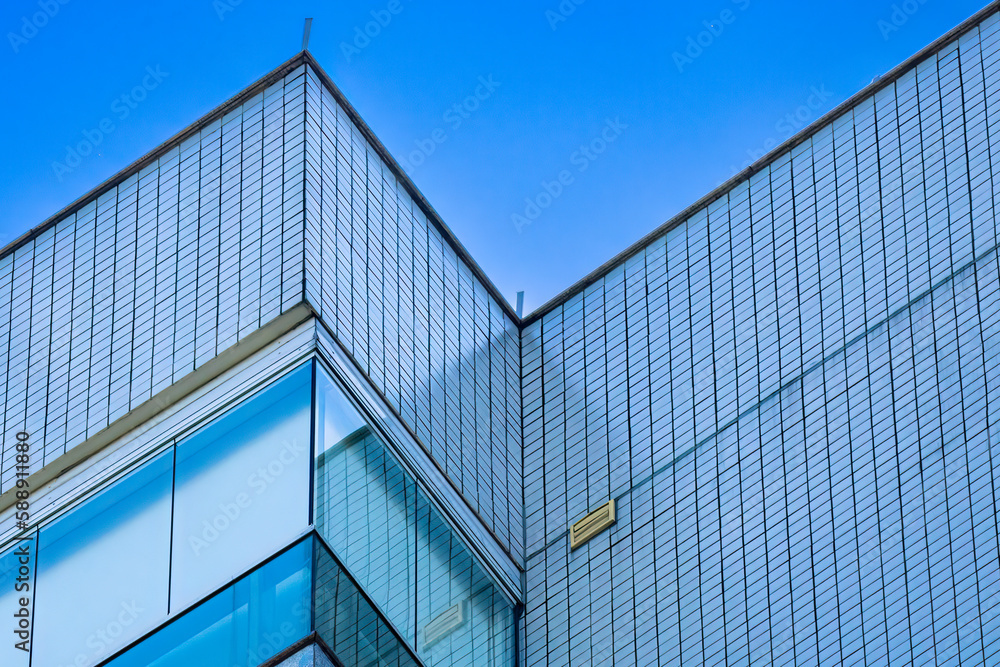 Detail of the top of a residential building showing details of the geometry of the balconies and glazing. Detail of the top of a residential building showing details of the geometry of the balconies and glazing.