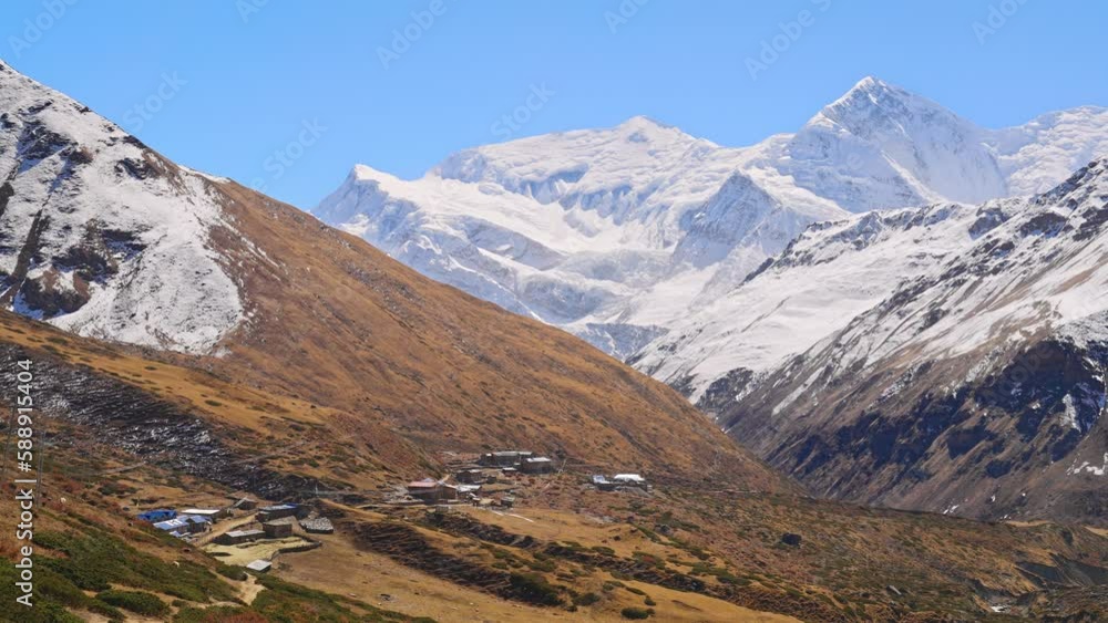 Dramatic panoramic view of Himalayan mountain range during autumn with snowy peaks, small villages, and natural landscape, Annapurna Circuit Trek, Nepal Dramatic panoramic view of Himalayan mountain range during autumn with snowy peaks, small villages, and natural landscape, Annapurna Circuit Trek, Nepal