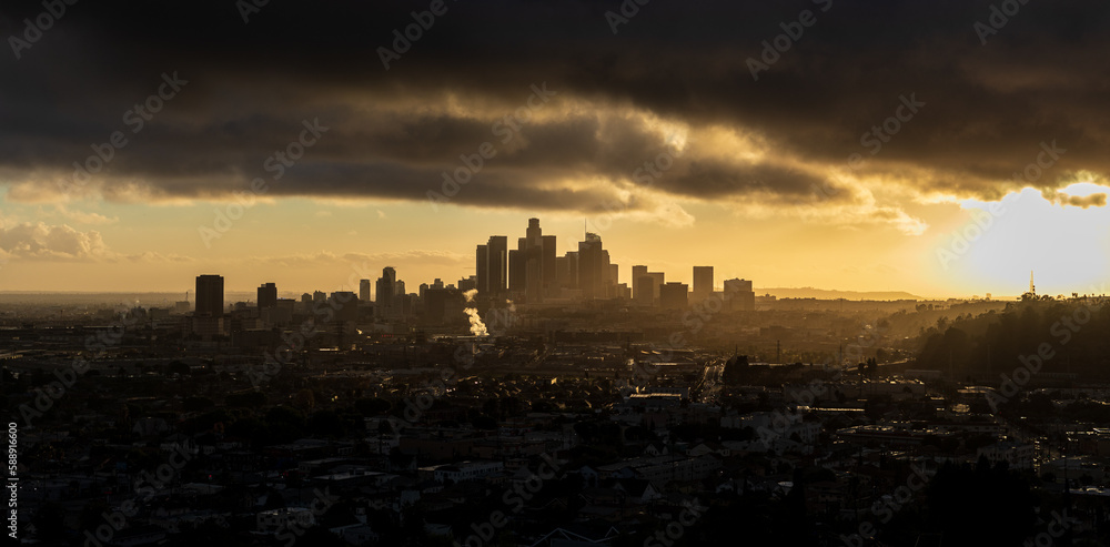 Moody Downtown Los Angeles at Golden Hour with the sun peaking through the clouds 