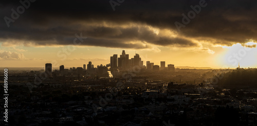 Moody Downtown Los Angeles at Golden Hour with the sun peaking through the clouds 