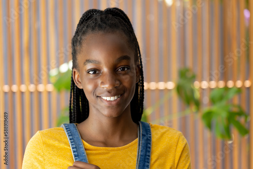 Portrait of happy african american teenager girl looking at camera and smiling