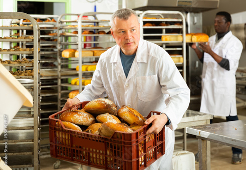 Successful baker during daily work in bakeshop. High quality photo