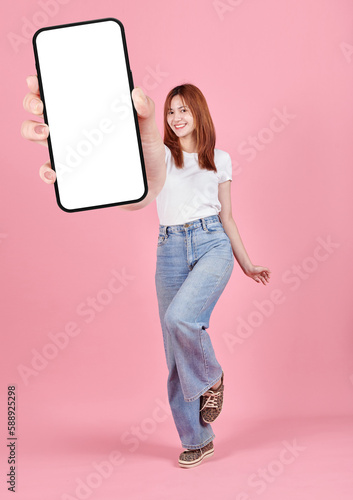Wallpaper Mural Asian young woman showing smart phone with blank screen , white screen for Mobile App Advertising isolated on pink background ,Cell phone display Mock Up Image. Torontodigital.ca