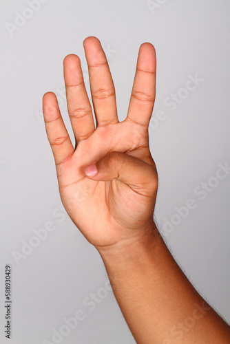 Hand shows number four , Number four index finger isolated background © hujan
