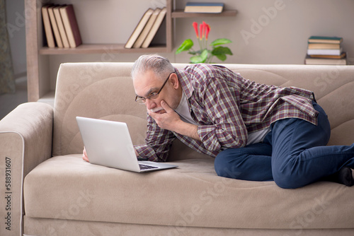 Old man working from home during pandemic