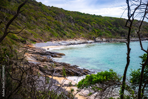 A beautiful cameral hidden little cove bay covered with greenery in Noosa National Park, Queensland, Australia