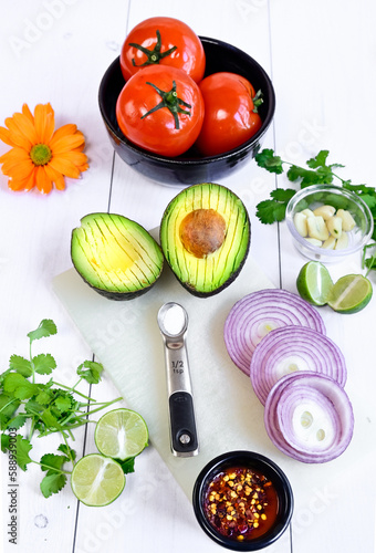 Food, Avocado and fresh cilantro, onion and tomato to prepare guacamole top view white background