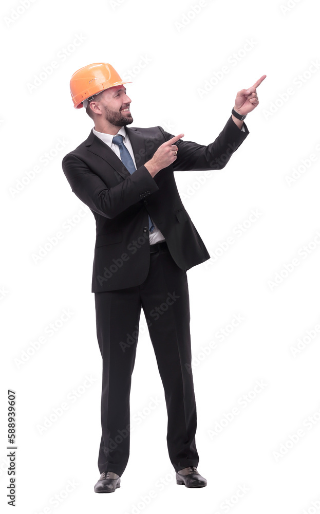 in full growth. serious businesswoman in helmet pointing somewhere to the side in full growth. serious businesswoman in helmet pointing somewhere to the side