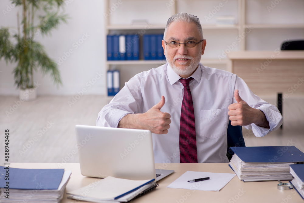 Old male employee and too much work at workplace Old male employee and too much work at workplace