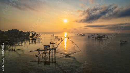 The sunrise in the bays with a wood of fish hunt on Thailand