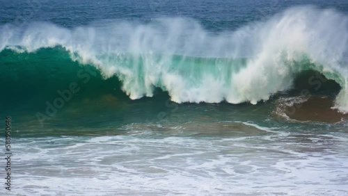 Huge ocean surf barrelling in super slow motion. Powerful wave rolling breaking photo