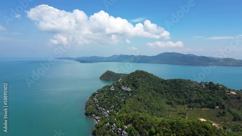 Hyperlapse drone video over tropical resort island in blue ocean photo