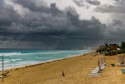 Dark and Stormy Clouds over Cancun, Mexico with Blue Water