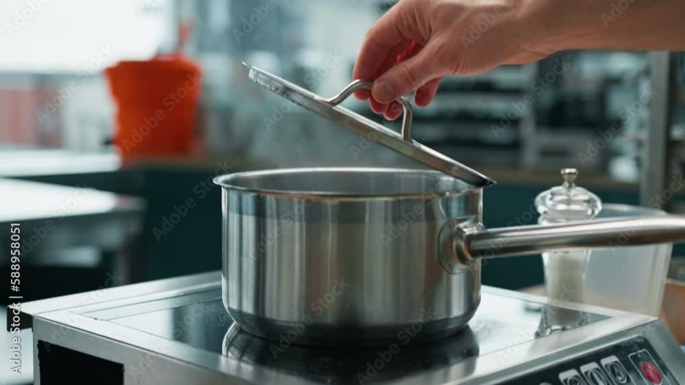 professional kitchen chef checks the readiness of the dish by lifting