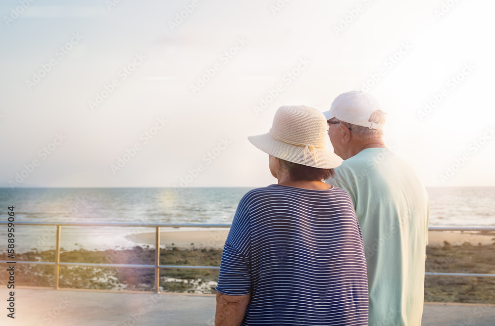 Seniors couple walk along the promenade