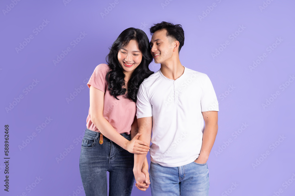 Fototapeta premium image of asian couple posing on purple background