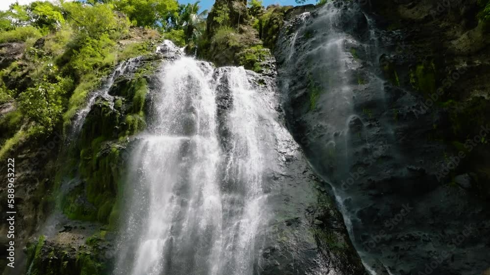 Aerial drone of Waterfall among tropical jungle with green plants. Slow motion. Balea Falls in the jungle. Negros, Philippines. Aerial drone of Waterfall among tropical jungle with green plants. Slow motion. Balea Falls in the jungle. Negros, Philippines.