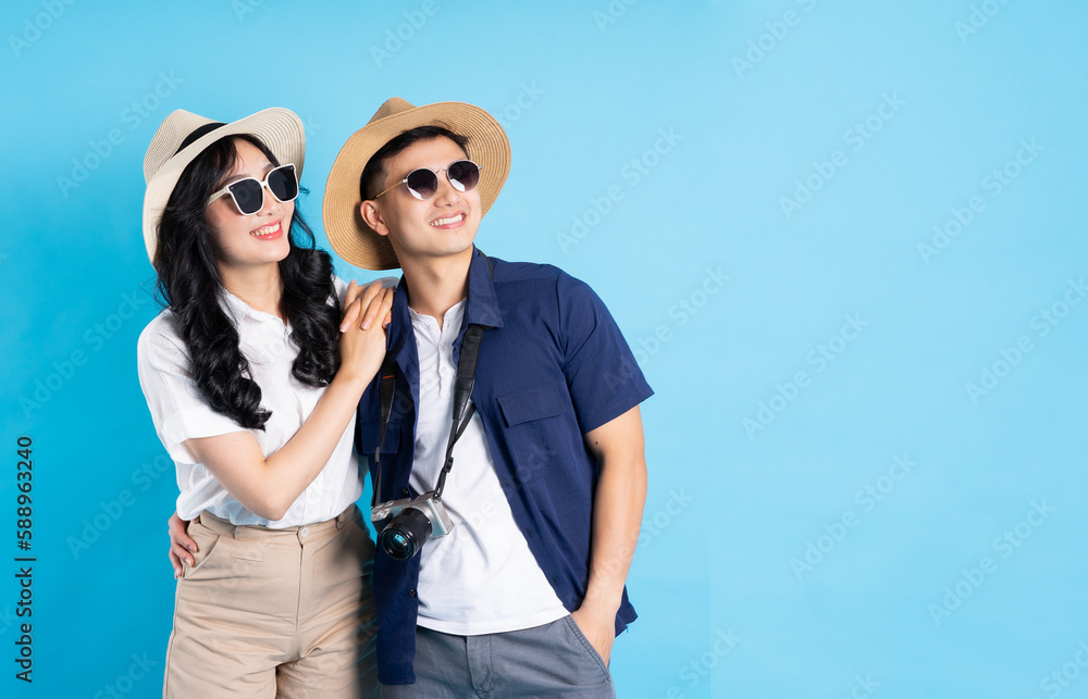 Asian couple traveling image isolated on blue background Asian couple traveling image isolated on blue background