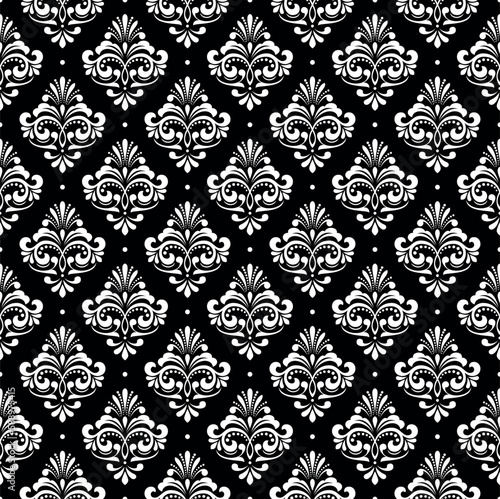 Wallpaper in the style of Baroque. Seamless vector background. White and black floral ornament. Graphic pattern for fabric, wallpaper, packaging. Ornate Damask flower ornament