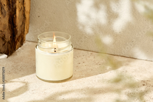 Photography Simple composition with aromatic burning candle in jar