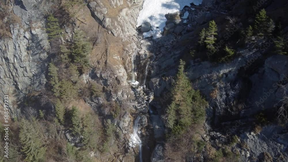 Aerial descent towards ice and snow melting into a waterfall. Cascade de L'Arpenaz, french Alps. Aerial descent towards ice and snow melting into a waterfall. Cascade de L'Arpenaz, french Alps.
