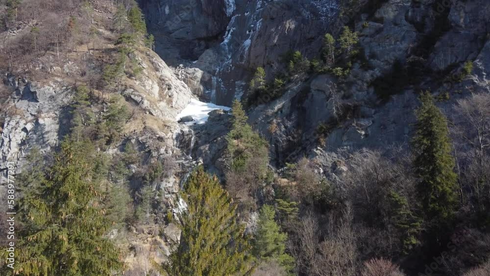 Flying towards the Arpenaz waterfall. Sallanches, french Alps. Ice and snow melting into the flow. Flying towards the Arpenaz waterfall. Sallanches, french Alps. Ice and snow melting into the flow.