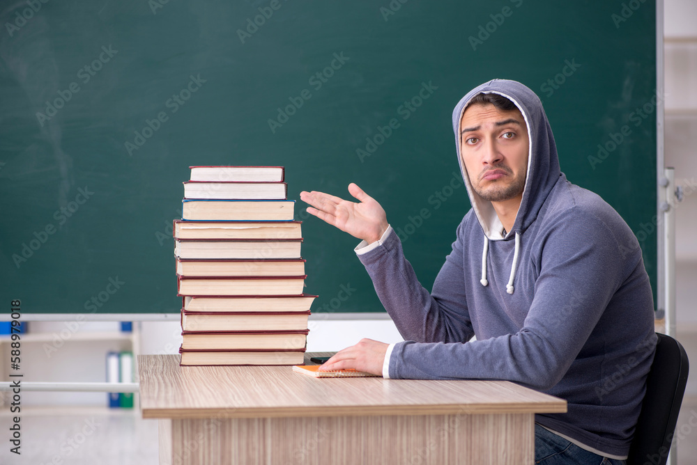 Young male student sitting in the classroom Young male student sitting in the classroom