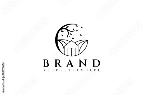 house and tree logo with hill background in circle frame