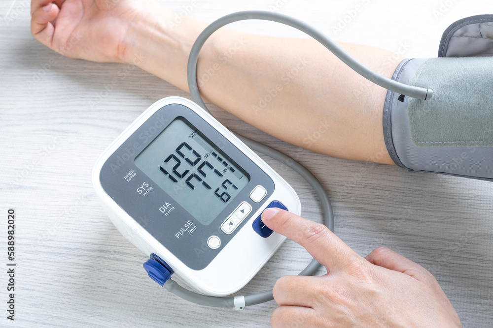 Man checks blood pressure monitor and heart rate monitor with digital pressure gauge. Health care and Medical concept. Man checks blood pressure monitor and heart rate monitor with digital pressure gauge. Health care and Medical concept.
