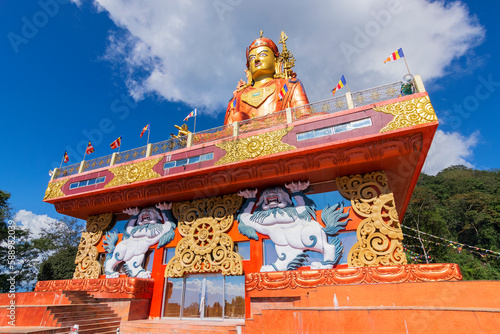 Wide angle view of Holy statue of Guru Padmasambhava or born from a lotus, Guru Rinpoche, Blue sky and white clouds, Samdruptse, Sikkim, India.