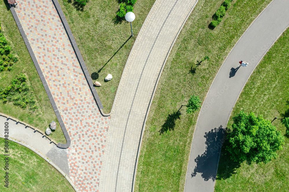 city park landscape in sunny summer day with footpaths through green lawn. aerial top view. city park landscape in sunny summer day with footpaths through green lawn. aerial top view.