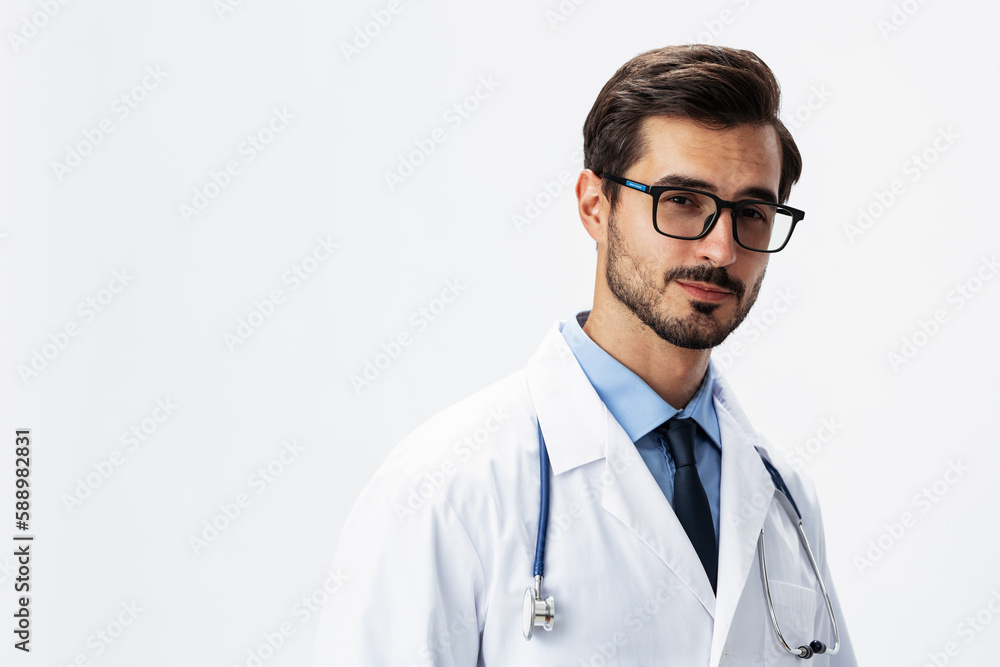 Male smile doctor in a white coat and eyeglasses and a stethoscope looks at the camera on a white isolated background, copy space, space for text, health Male smile doctor in a white coat and eyeglasses and a stethoscope looks at the camera on a white isolated background, copy space, space for text, health