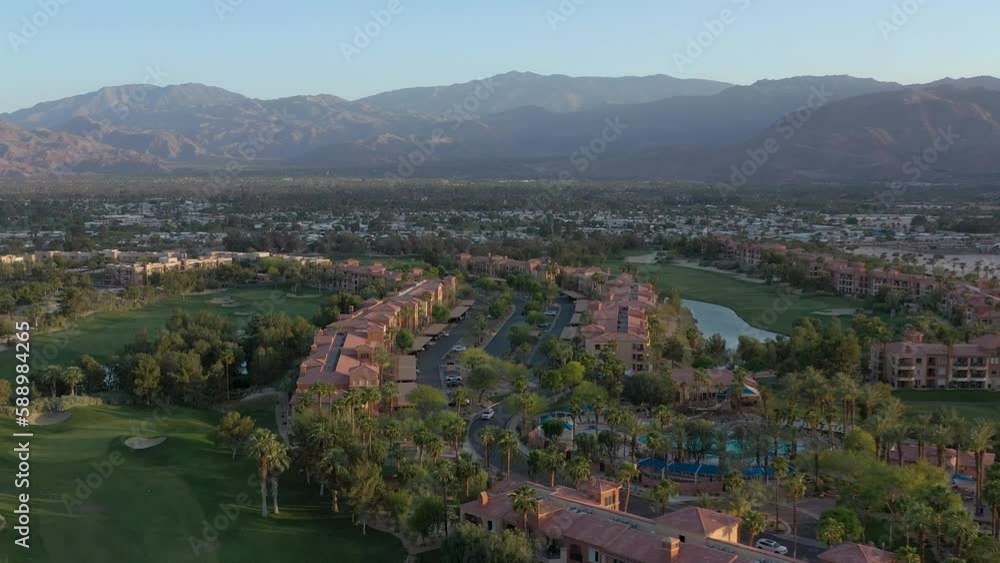 Aerial drone orbit of vacation resort in Palm Springs california and San Jacinto mountains in the distance.