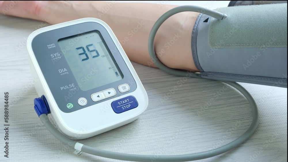 Man checks blood pressure monitor and heart rate monitor with digital pressure gauge. Health care and Medical concept. Man checks blood pressure monitor and heart rate monitor with digital pressure gauge. Health care and Medical concept.