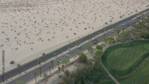 Aerial drone shot following cars traveling on the road southern California.