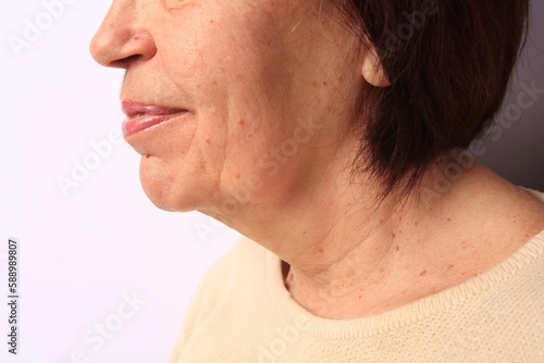 Closeup view of older woman on white background