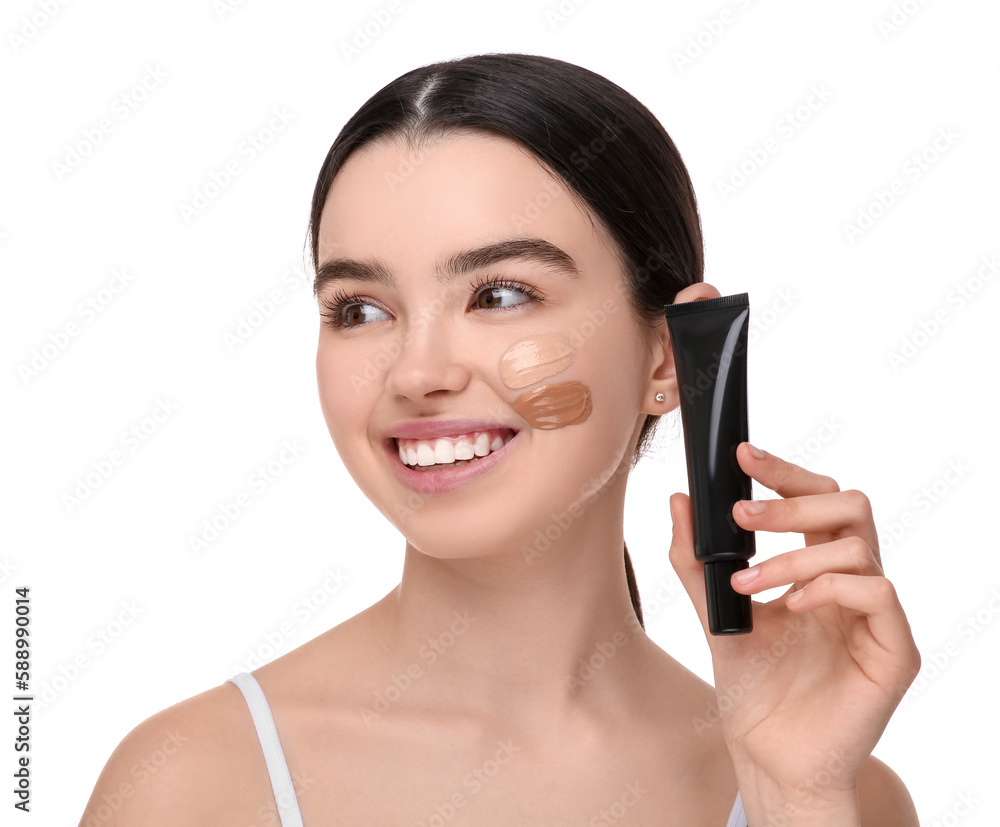 Teenage girl holding tube of foundation on white background Teenage girl holding tube of foundation on white background