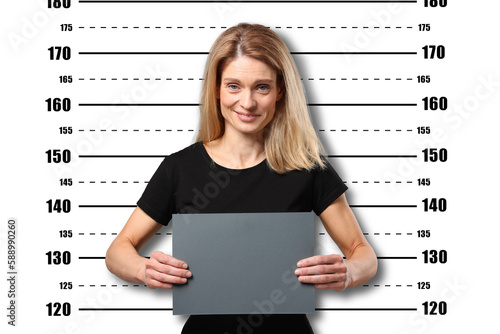 Criminal mugshot. Arrested woman with blank card against height chart photo